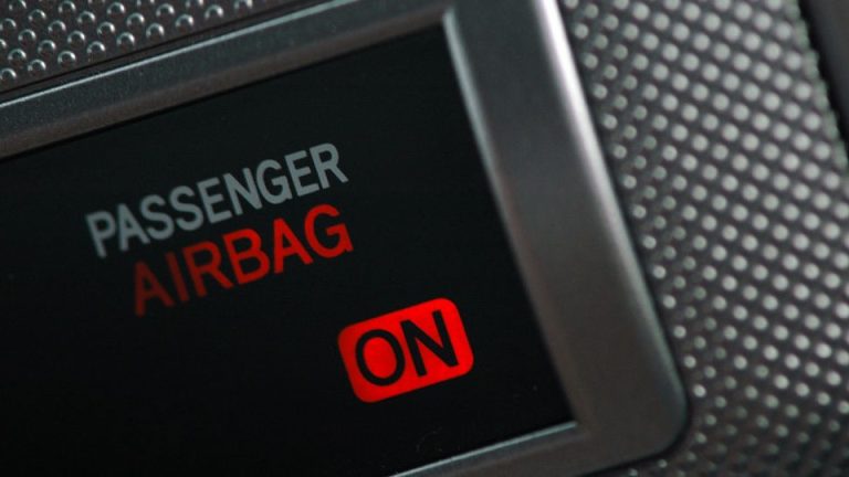 The dashboard of a car features a passenger airbag for safety.