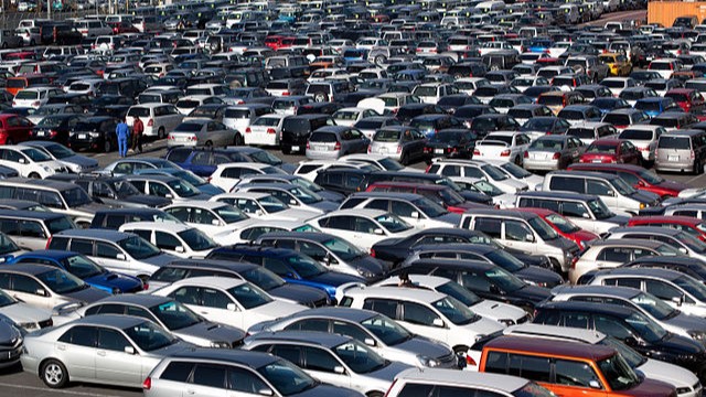 A large parking lot crowded with cars.
