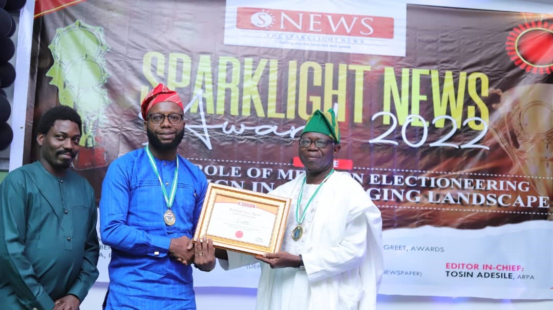 Two men proudly holding a plaque for Company of the Year.