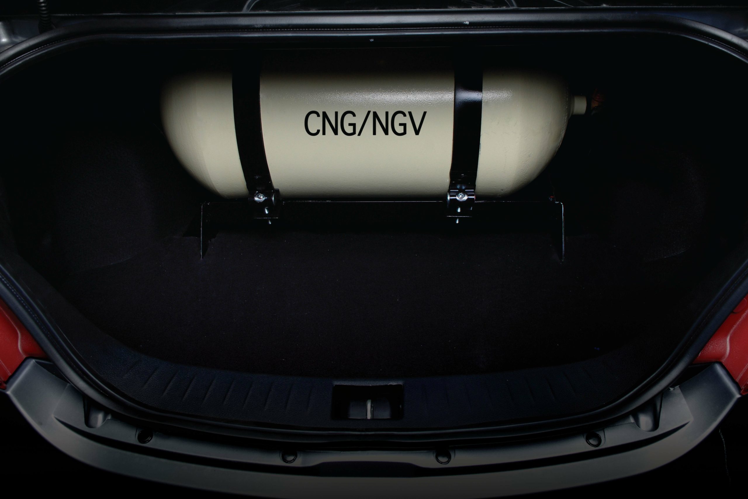A cng (compressed natural gas) tank installed in the trunk of a vehicle.