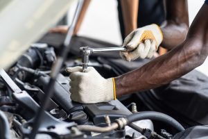 A person working on a car engine.