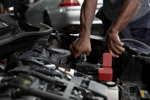 A mechanic working on a car engine.